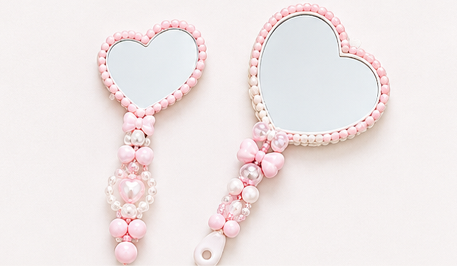 Skyla Studio pink heart-shaped mirrors with beaded charm handles