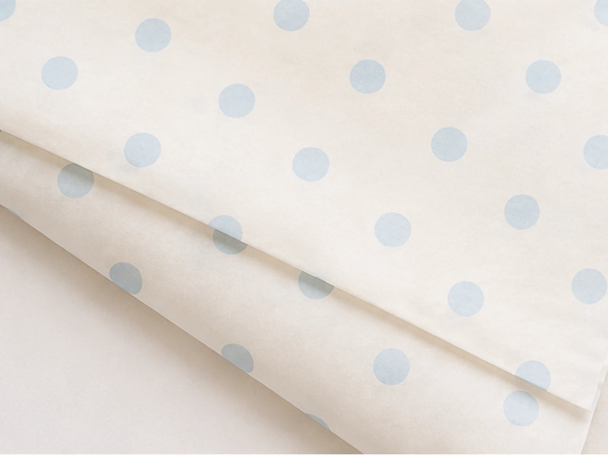 Cream gift tissue paper with baby blue polka dots used in Skyla Studio packaging