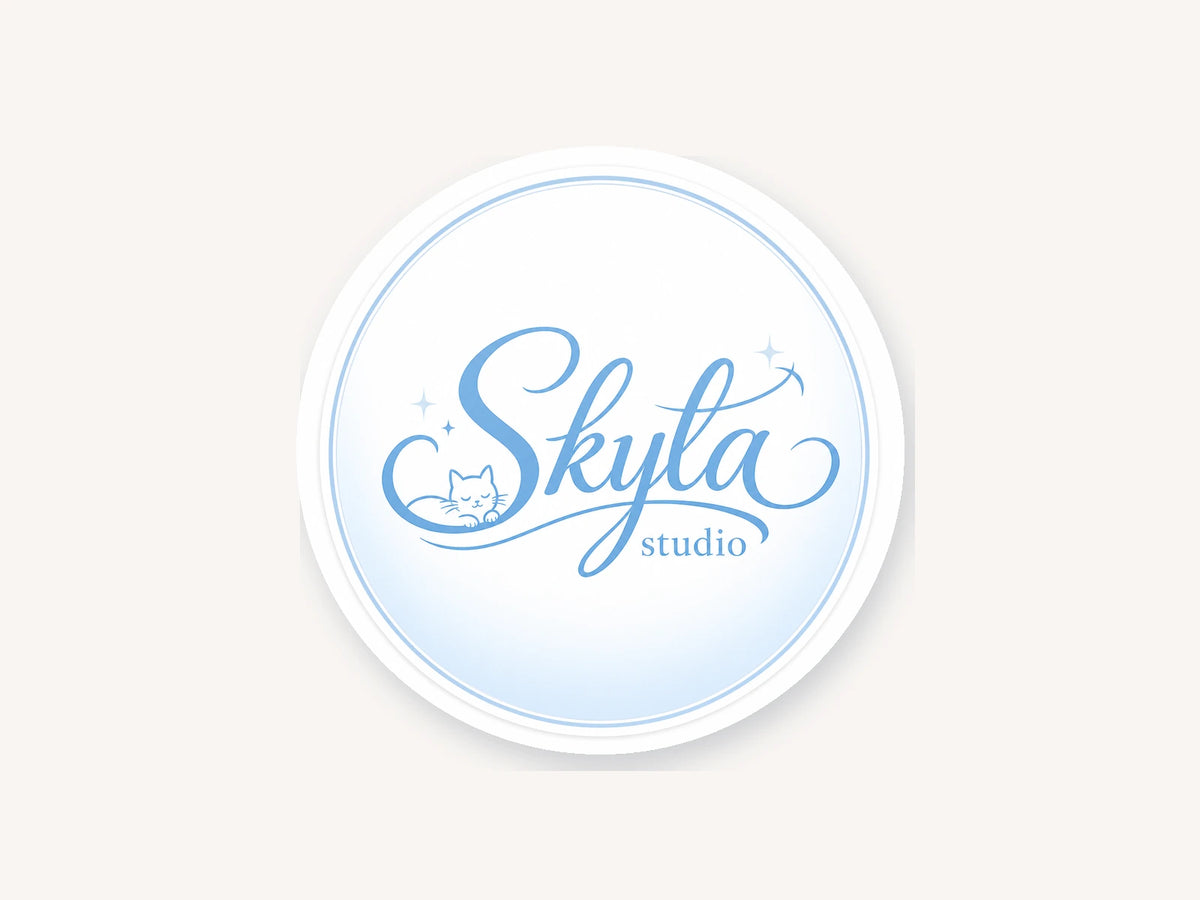 Round Skyla Studio baby blue logo sticker with sleeping cat illustration